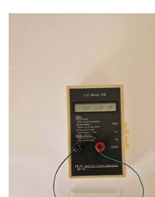 A finger touch through the glass changes the electrode capacitance by 1.3–1.6 pF.